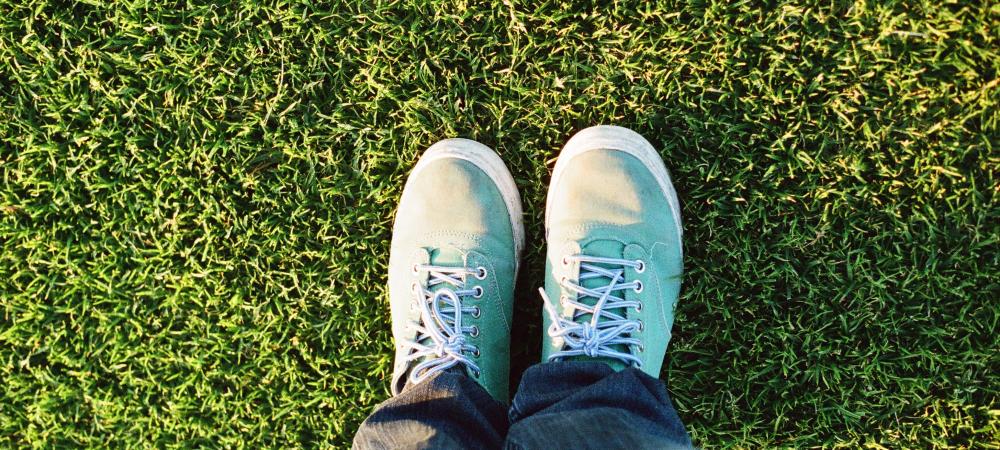 Someone standing on green grass